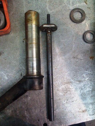 measuring the tool against the trailing arm to work out the correct depth for the inner bush